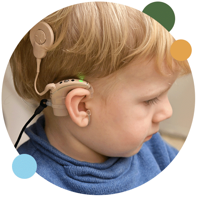 Young boy with hearing loss using cochlear implants