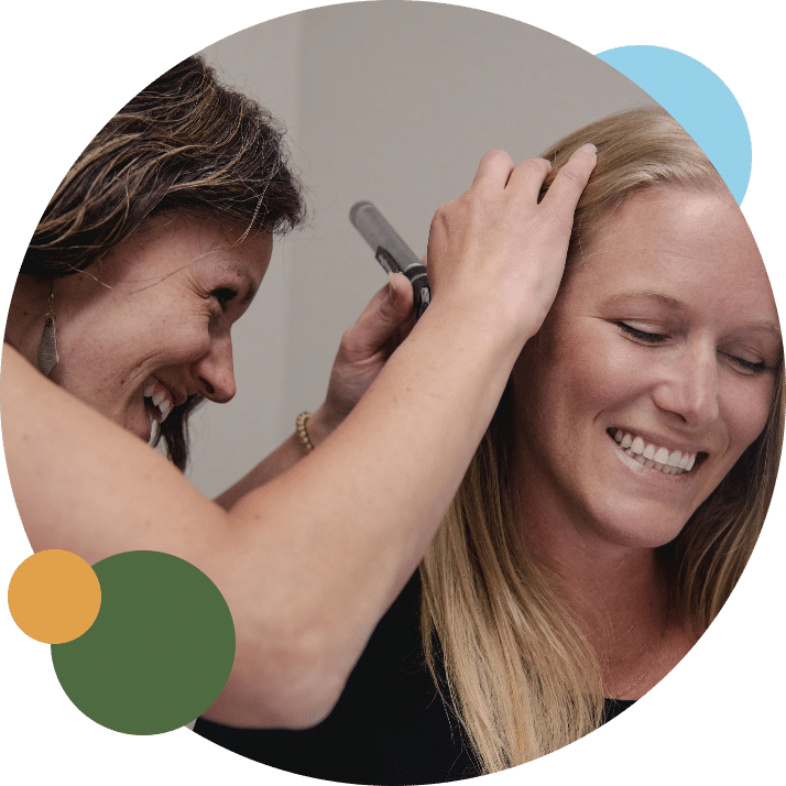 Audiologist at Tahoe Hearing Clinic. CA examining a patient's ears